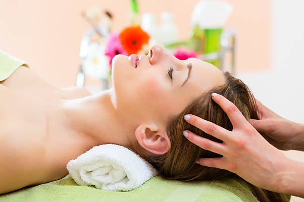 Wellness - woman receiving head or face massage in spa